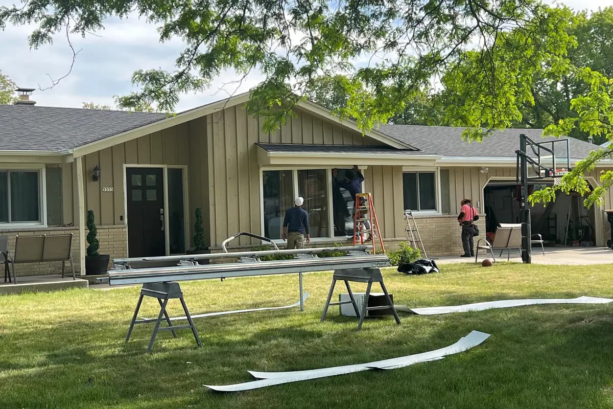Roofing and gutter materials staged on the lawn of a Brookfield, WI home during an Apexium Roofing install