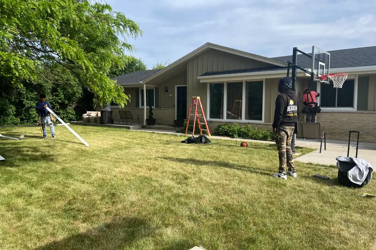 Apexium Roofing crew setting ladders for a roof replacement on a single-story ranch in Brown Deer, WI