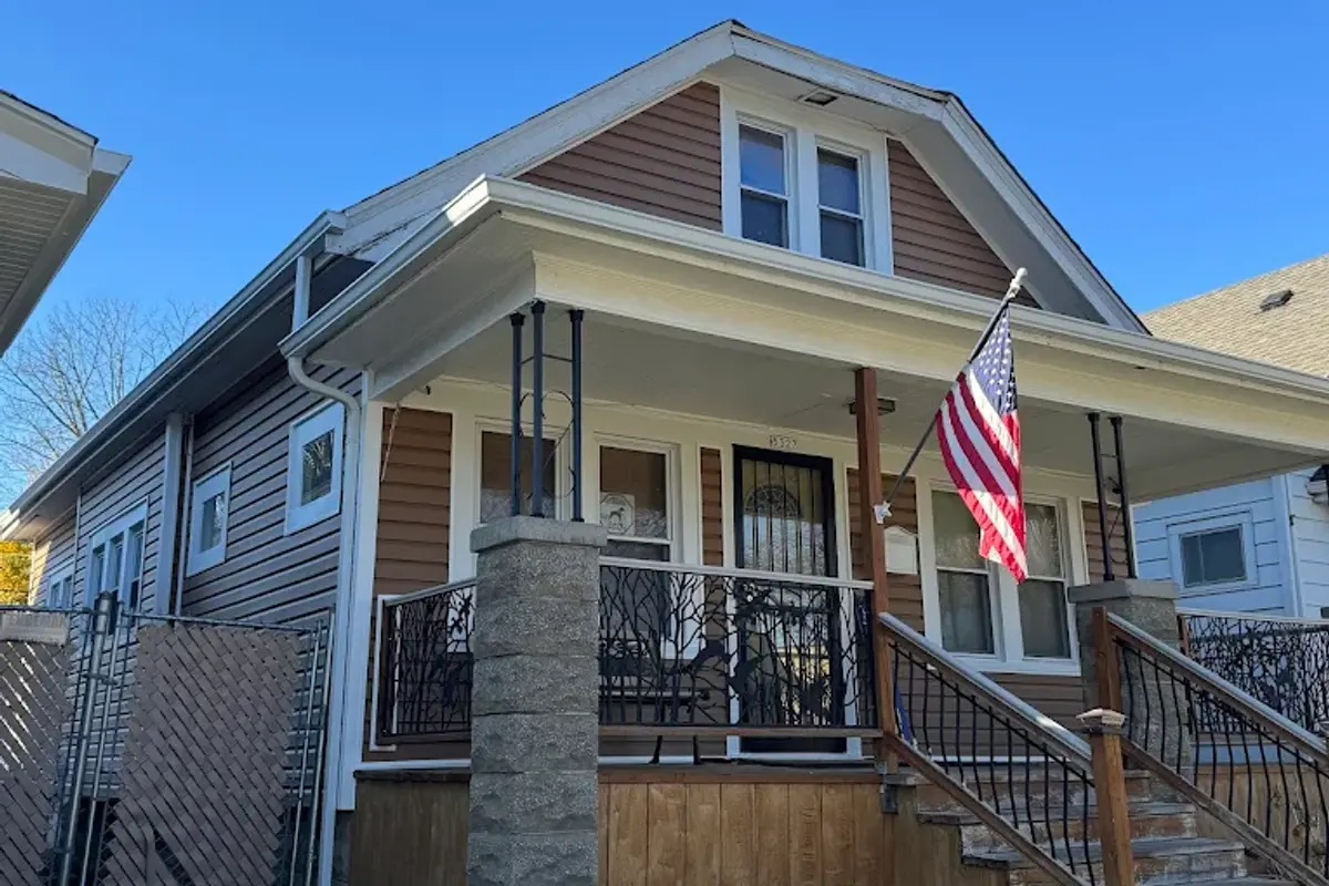 Completed roof replacement on a classic West Allis, WI bungalow with a covered front porch