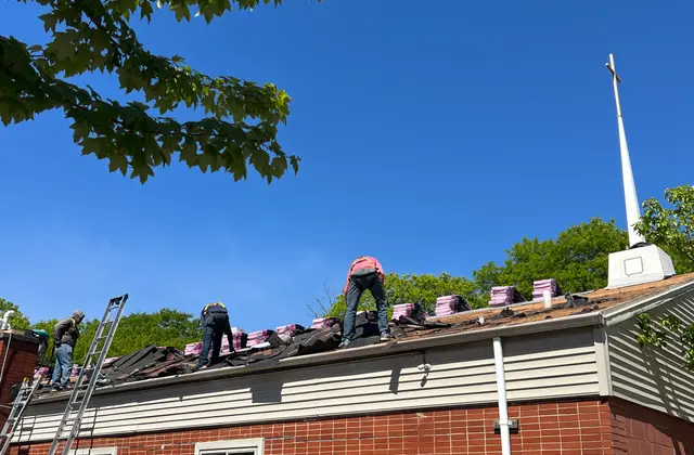 Apexium Roofing crew stripping an old roof back to the deck in Grafton, WI